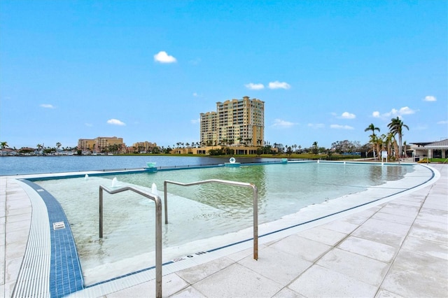 community pool featuring a patio area and a water view