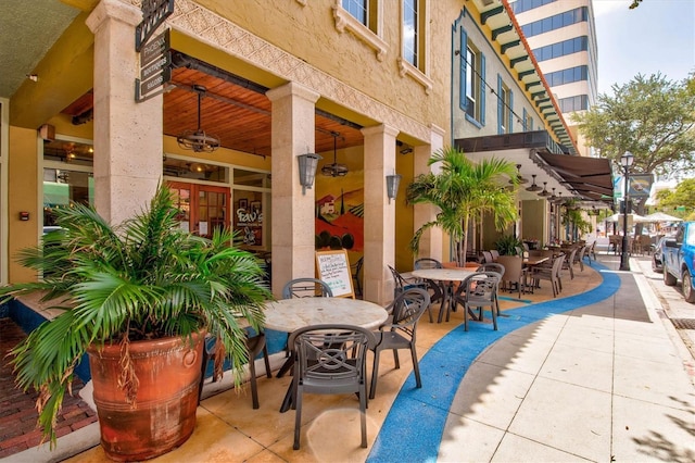 view of patio with outdoor dining area and ceiling fan