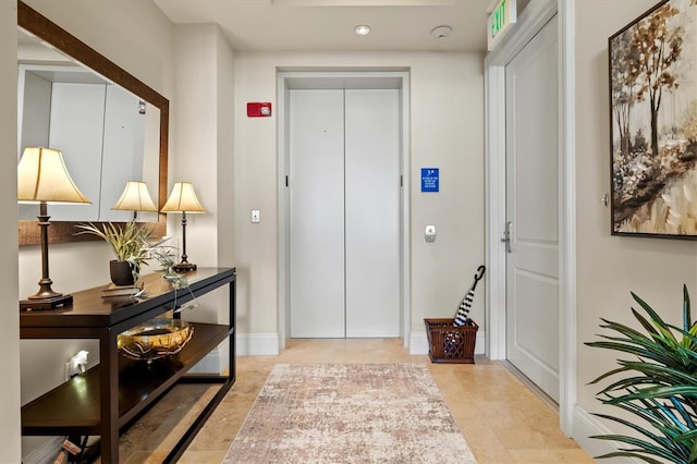 entryway featuring elevator and baseboards