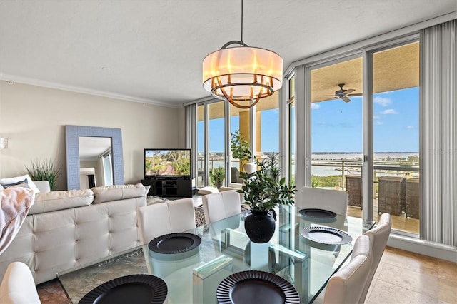 dining area featuring crown molding, a healthy amount of sunlight, an inviting chandelier, and floor to ceiling windows