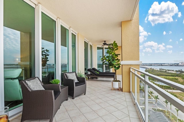 balcony featuring a water view and a sunroom