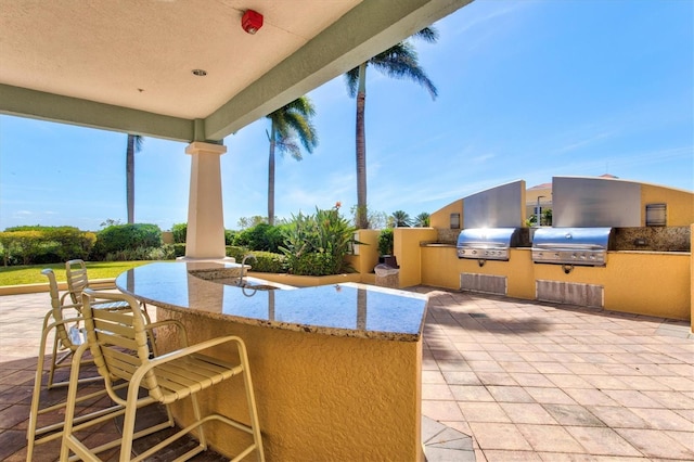 130 Riviera Dunes Way Unit 1104, Palmetto, FL 34221 - view of patio / terrace featuring an outdoor kitchen, outdoor wet bar, and a grill