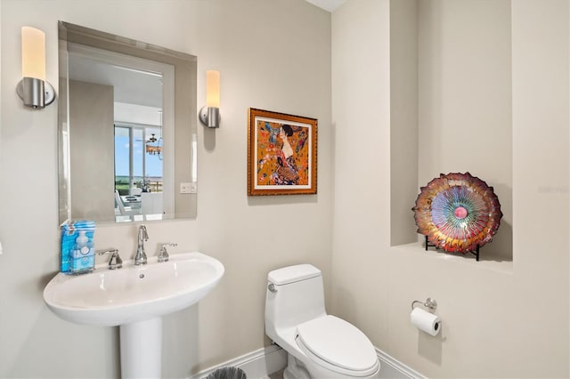 130 Riviera Dunes Way Unit 1104, Palmetto, FL 34221 - bathroom featuring baseboards, toilet, and a sink