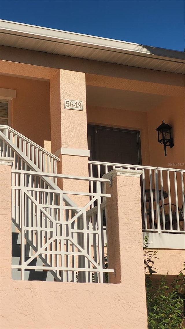 property entrance with stucco siding