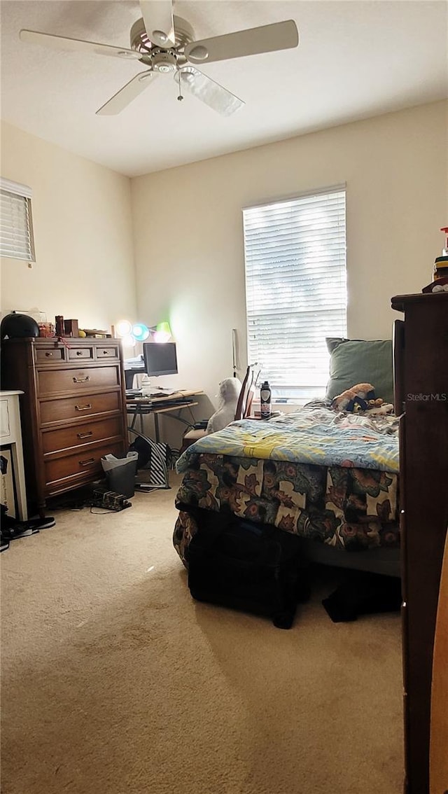 bedroom with ceiling fan and carpet flooring