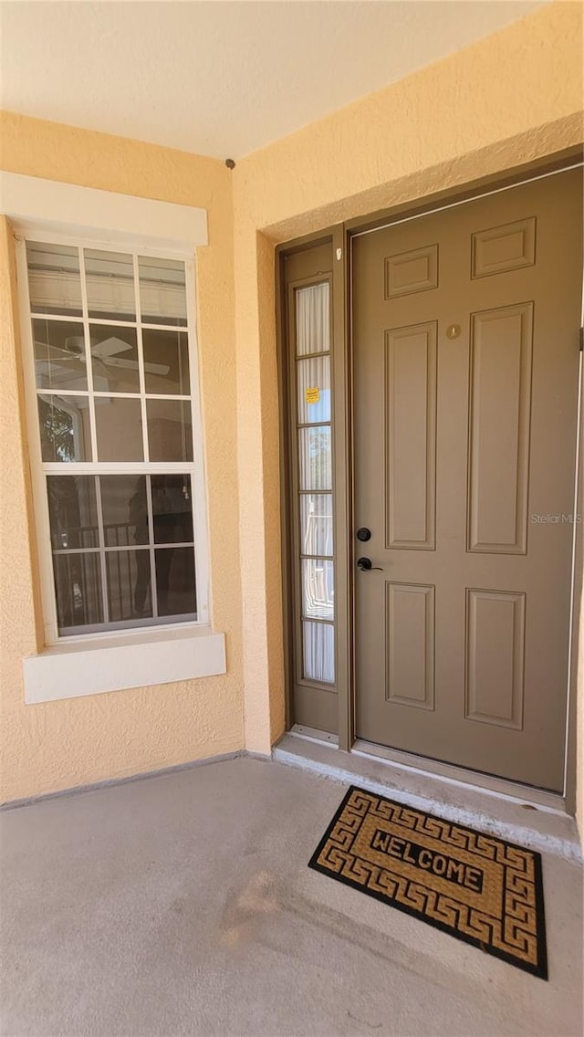 entrance to property with stucco siding