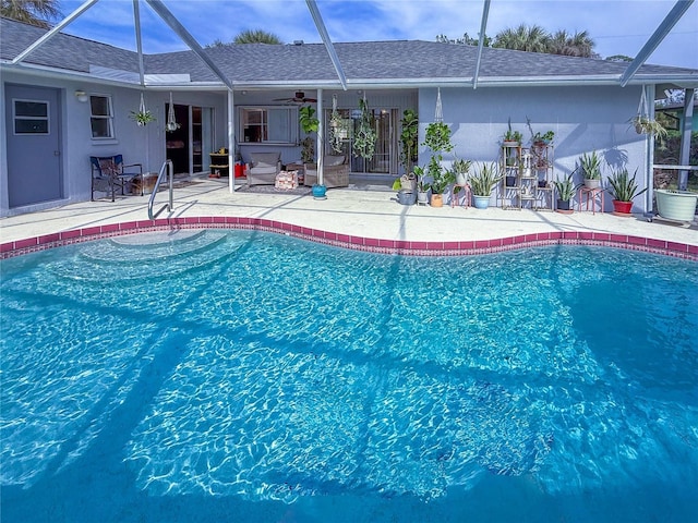 view of swimming pool with ceiling fan and a patio