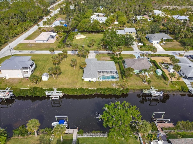 birds eye view of property with a water view and a residential view