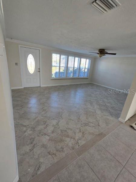 foyer featuring crown molding, plenty of natural light, and ceiling fan