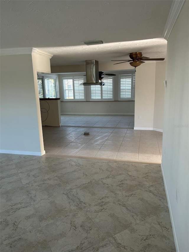 empty room with light tile patterned floors, crown molding, a textured ceiling, and ceiling fan