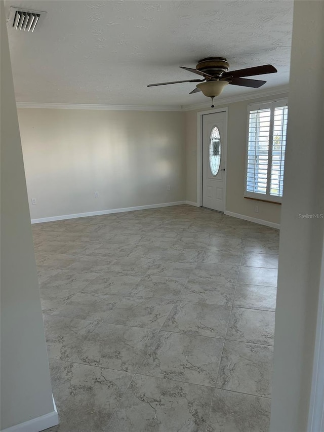 entryway featuring visible vents, baseboards, ceiling fan, a textured ceiling, and crown molding