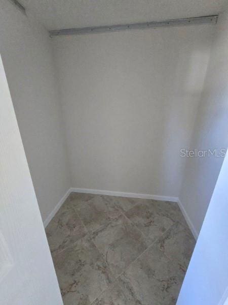 spare room featuring baseboards