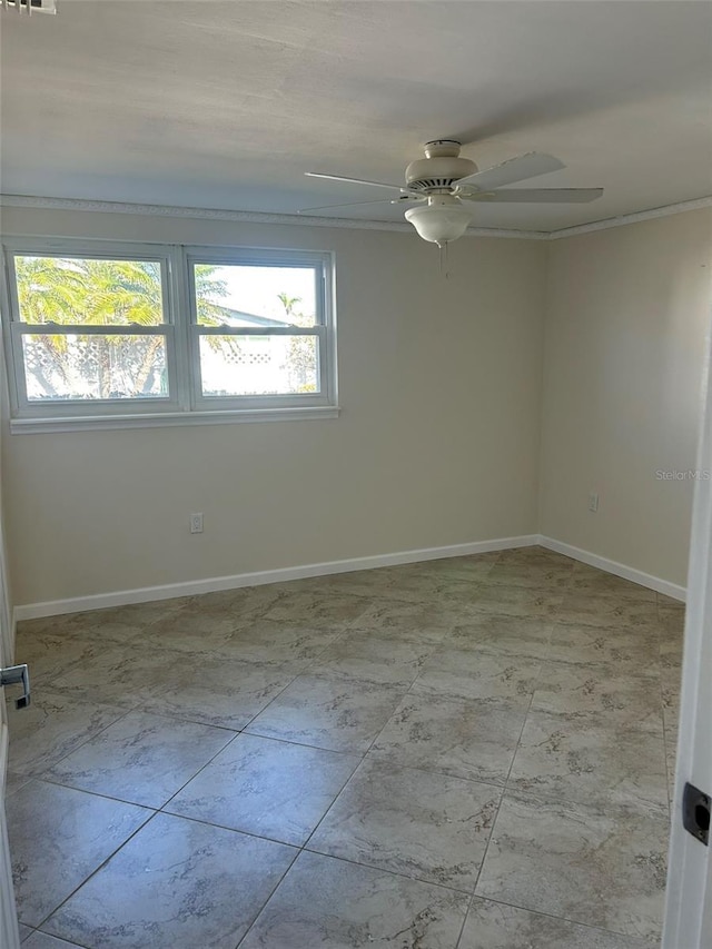 spare room featuring ceiling fan, baseboards, and ornamental molding