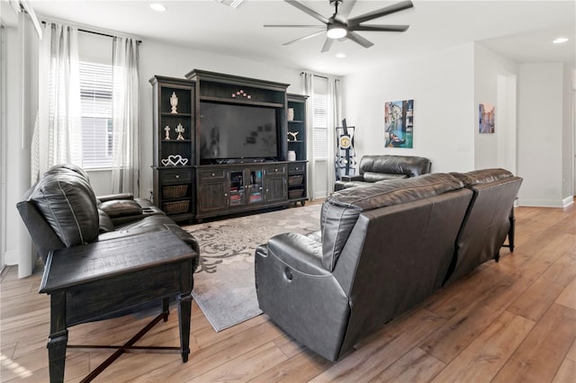 living room featuring ceiling fan and light wood-type flooring