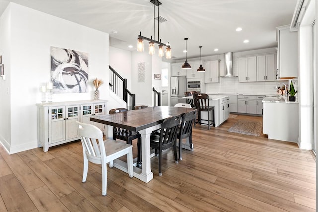 dining area featuring sink and light wood-type flooring