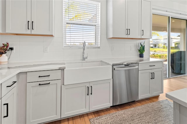 kitchen featuring sink, dishwasher, and white cabinets