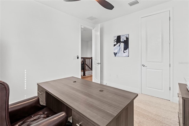 carpeted office with ceiling fan