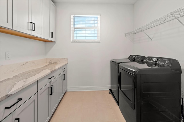 laundry area featuring cabinets and independent washer and dryer