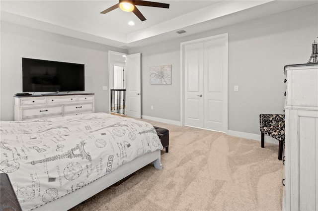 carpeted bedroom with ceiling fan and a closet