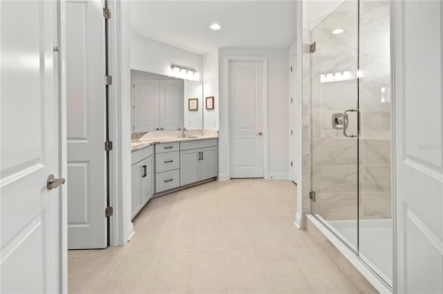 bathroom with vanity, a shower with shower door, and tile patterned floors