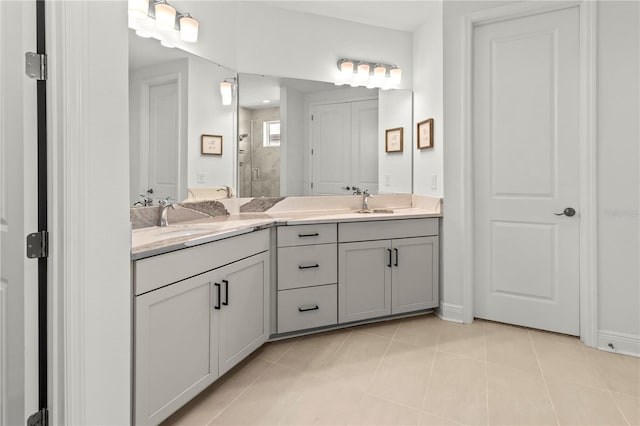 bathroom with a shower with door, tile patterned floors, and vanity