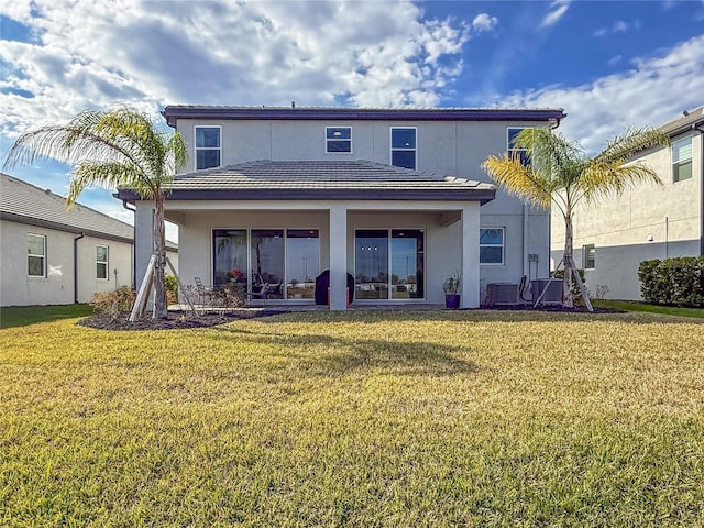 rear view of property featuring a yard