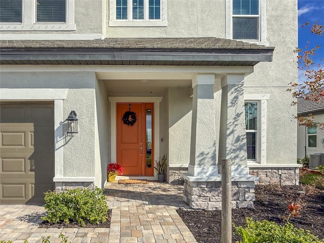 view of exterior entry featuring a garage