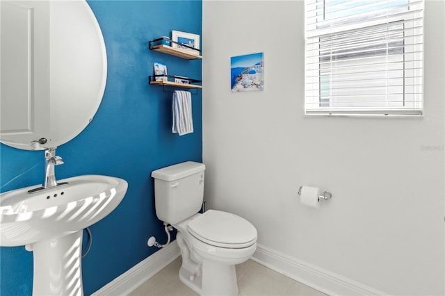 bathroom with toilet and tile patterned flooring