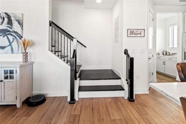 stairs featuring wood-type flooring