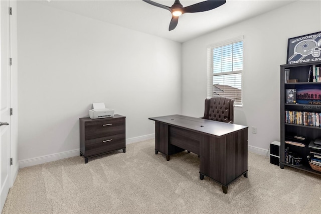 carpeted office space with ceiling fan