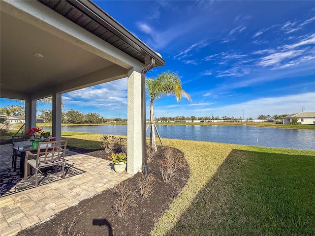 view of yard featuring a water view and a patio