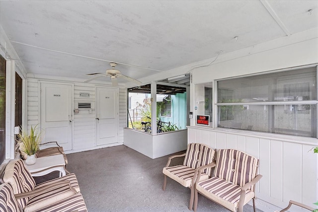 sunroom featuring ceiling fan