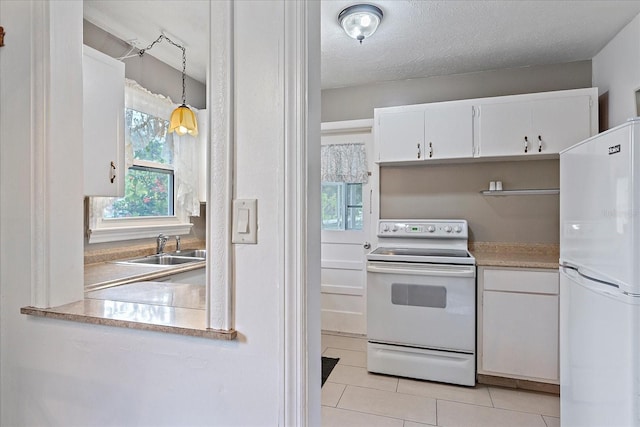 kitchen featuring pendant lighting, white appliances, sink, a textured ceiling, and white cabinetry