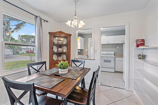 dining space with a notable chandelier and light tile patterned floors