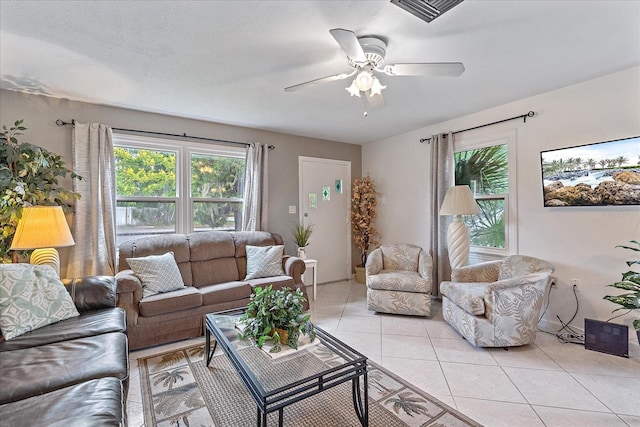 living room with ceiling fan and light tile patterned floors