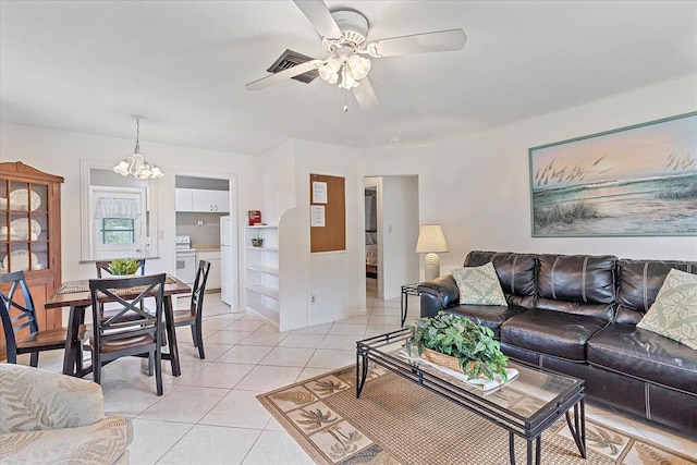 living room featuring ceiling fan with notable chandelier and light tile patterned flooring