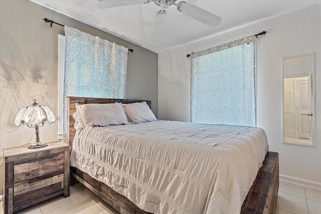 tiled bedroom featuring ceiling fan