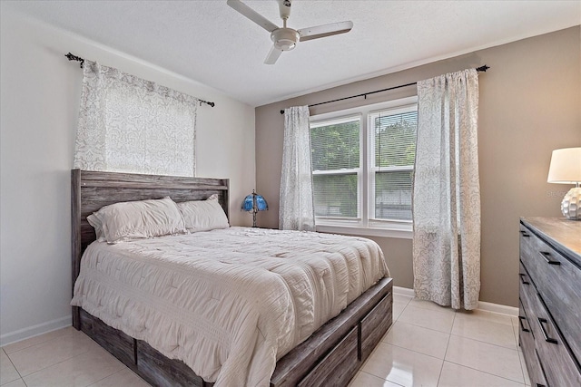 tiled bedroom with a textured ceiling and ceiling fan