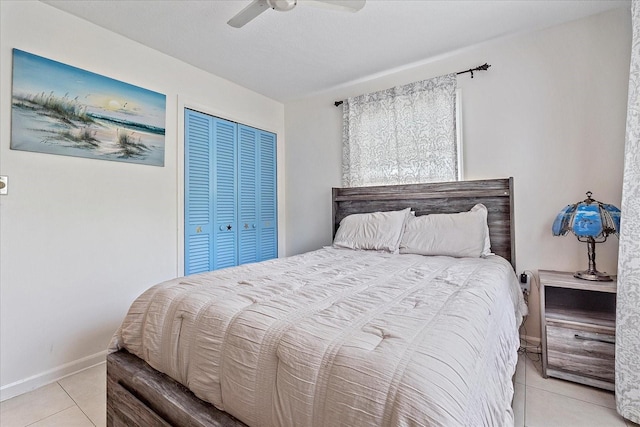 bedroom featuring ceiling fan, a closet, and light tile patterned flooring