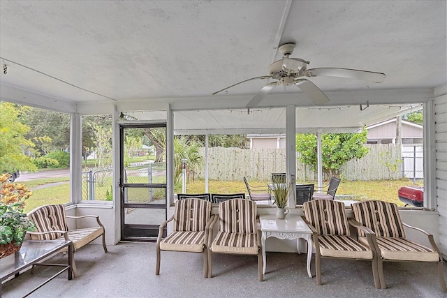 sunroom / solarium featuring ceiling fan