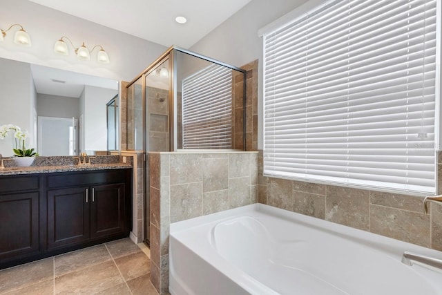 bathroom with shower with separate bathtub, vanity, and a wealth of natural light