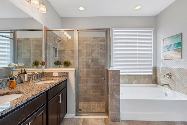 bathroom featuring vanity, plenty of natural light, and independent shower and bath