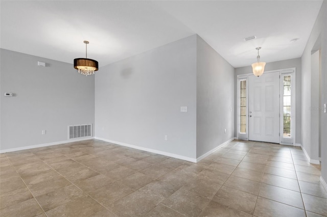 entryway featuring a notable chandelier