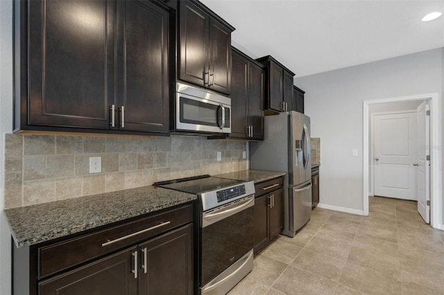 kitchen with dark brown cabinets, dark stone countertops, appliances with stainless steel finishes, and tasteful backsplash