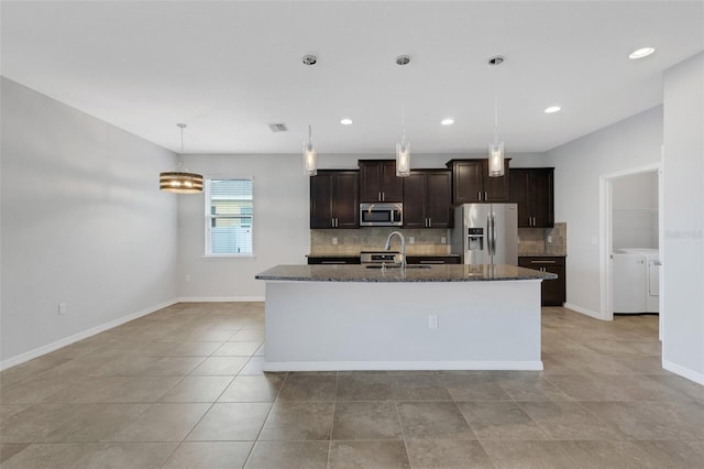 kitchen with sink, stainless steel appliances, separate washer and dryer, a kitchen island with sink, and dark brown cabinets