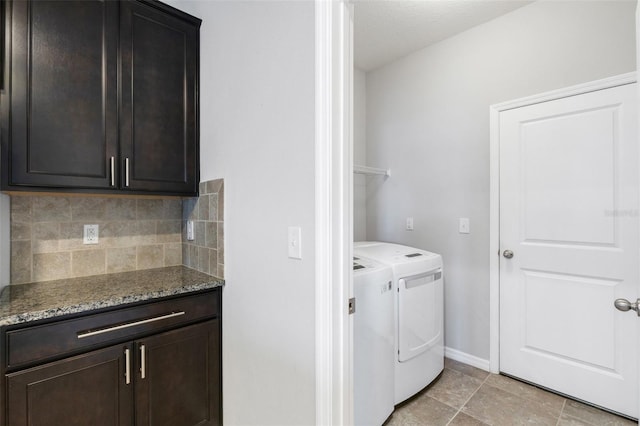 laundry area with cabinets and washer and clothes dryer