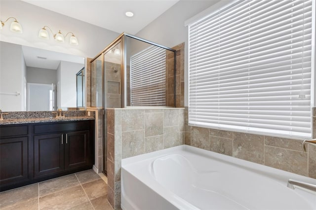 bathroom featuring vanity and separate shower and tub