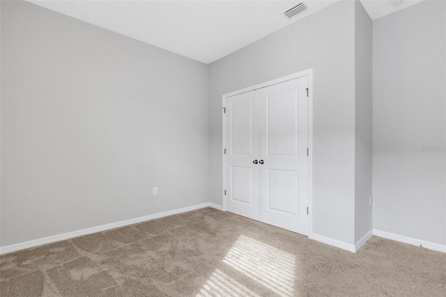 unfurnished bedroom with carpet and a closet