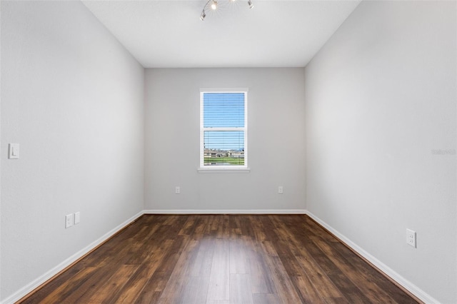 spare room with dark hardwood / wood-style flooring