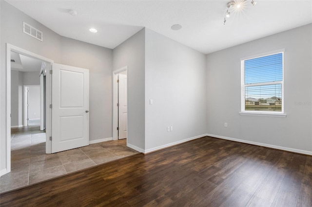 unfurnished room with dark hardwood / wood-style flooring